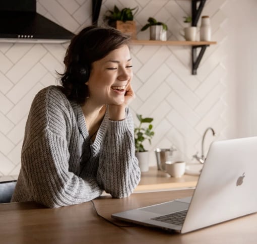 A woman having a video call in her kitchen.