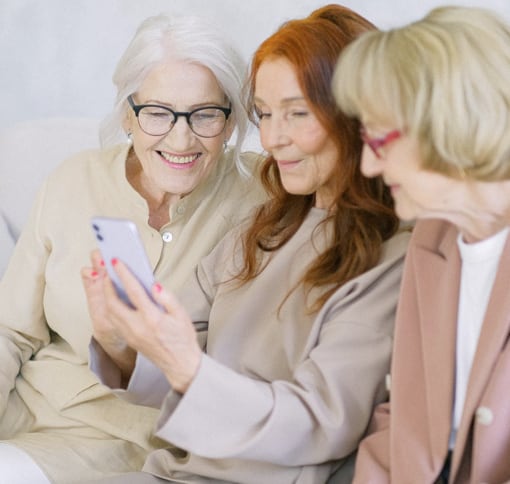 Three women having a video call on a phone.